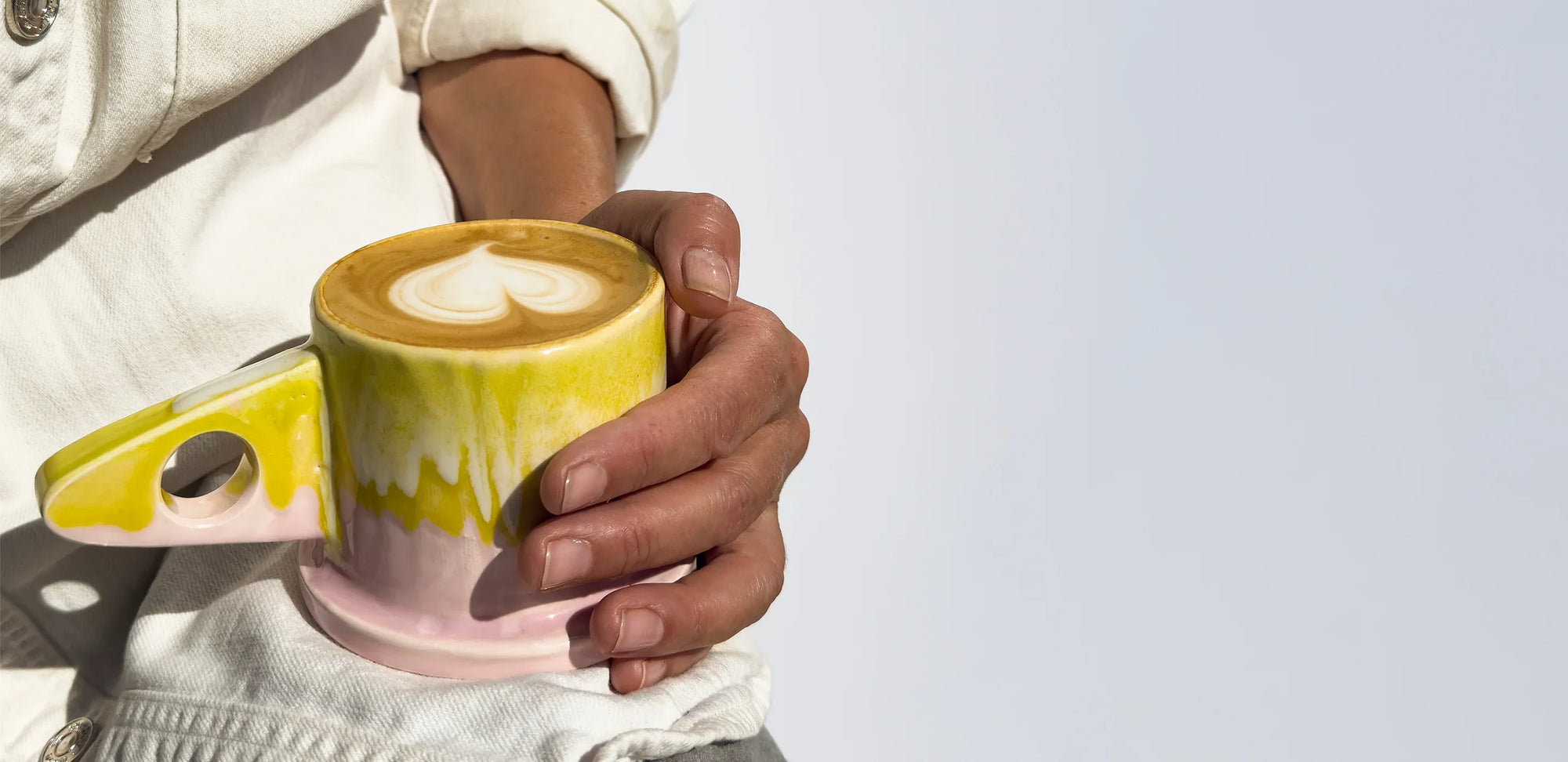 holding-latte-yellow-mug